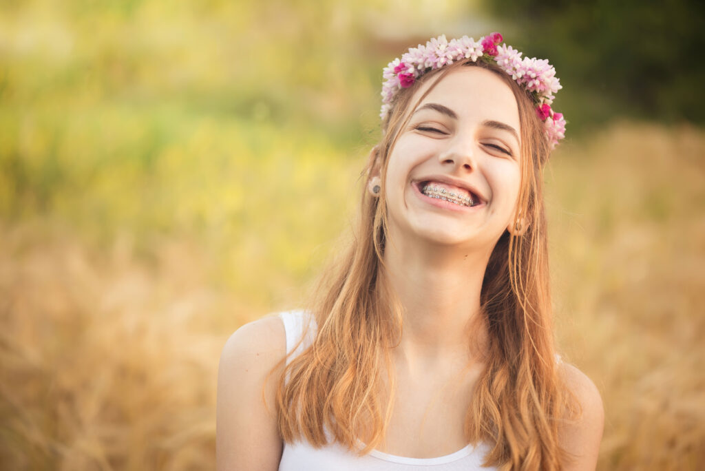 Young teen with braces smiliing during summer vacation